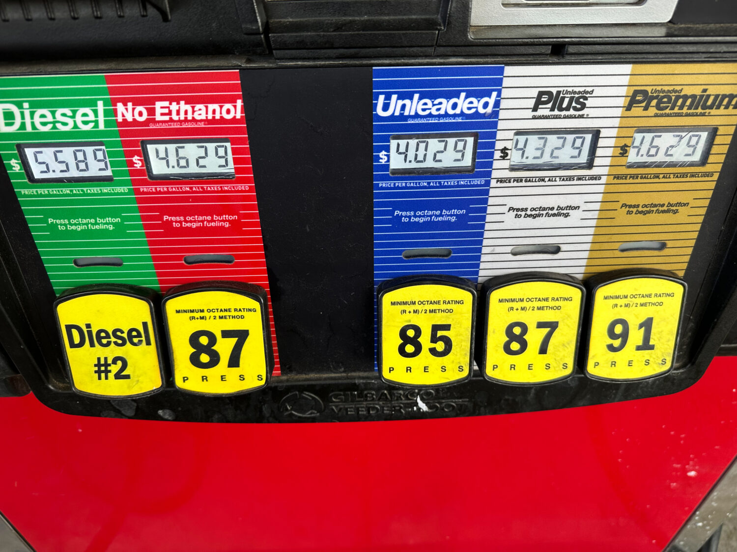 The per-gallon prices are displayed above the various grades of fuel available at a pump at a QuikT...