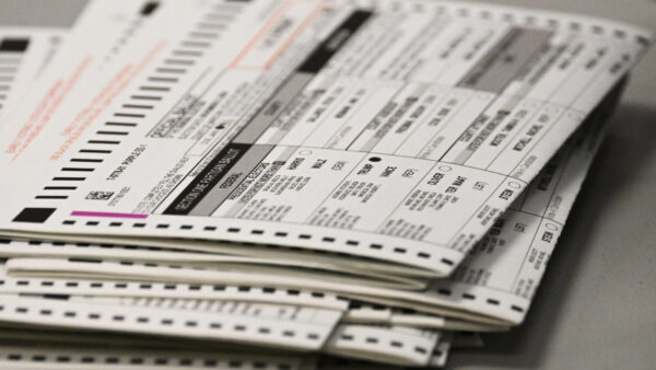 TOPSHOT - A ballot marked for Trump sits in a stack of voted ballots inside the Maricopa County Tabulation and Election Center (MCTEC) on Election Day, November 5, 2024 in Phoenix, Arizona. Pairs of election workers from different political parties open mail-in ballot envelopes containing voted ballots after they completed signature verification. (Photo by Patrick T. Fallon / AFP) (Photo by PATRICK T. FALLON/AFP via Getty Images)