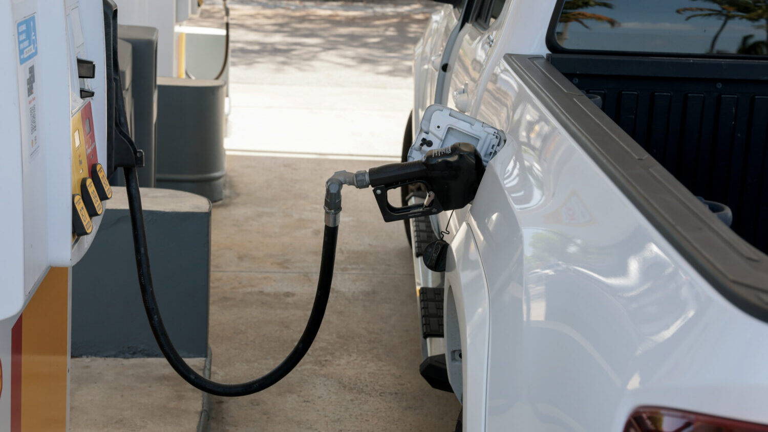 A customer fills their vehicle with fuel at a gas station. (Photo by Joe Raedle/Getty Images)...