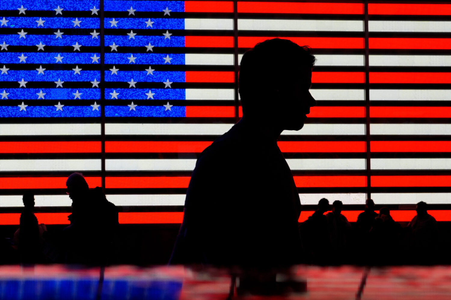 FILE - People stand in Times Square in New York, Friday, Aug. 9, 2024. (AP Photo/Pamela Smith, File...