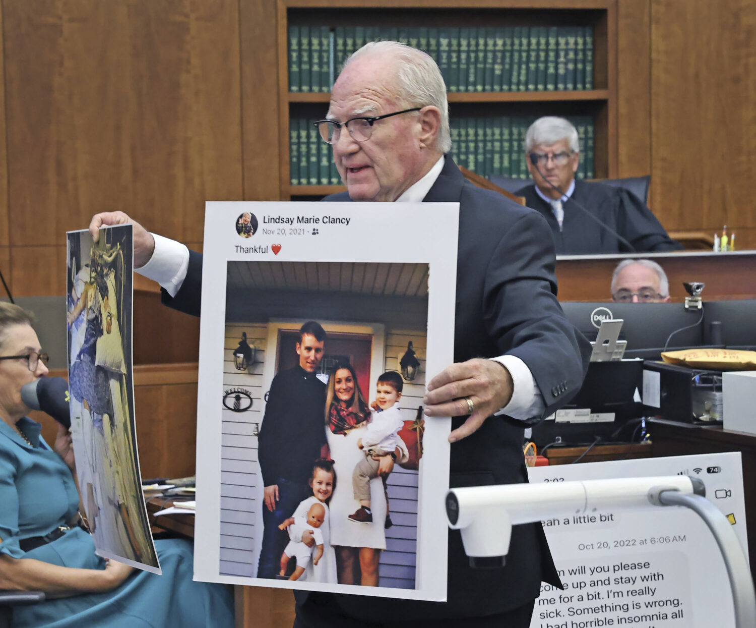 Defense attorney Kevin Reddington holds up a picture of th Clancy family before the murders during ...