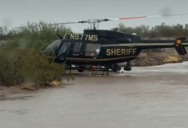 Crews arrived to find the brown sedan surrounded by fast-moving water, which had reached the hood and windows and was pouring into the cabin.