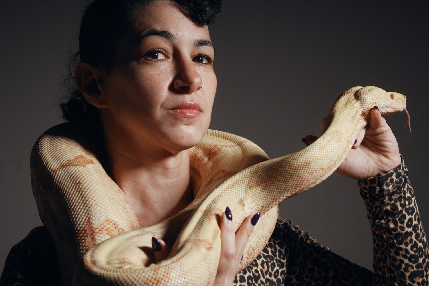 Performance artist Zoe Ziegfeld who plays the part of a snake charmer poses for a portrait with a s...