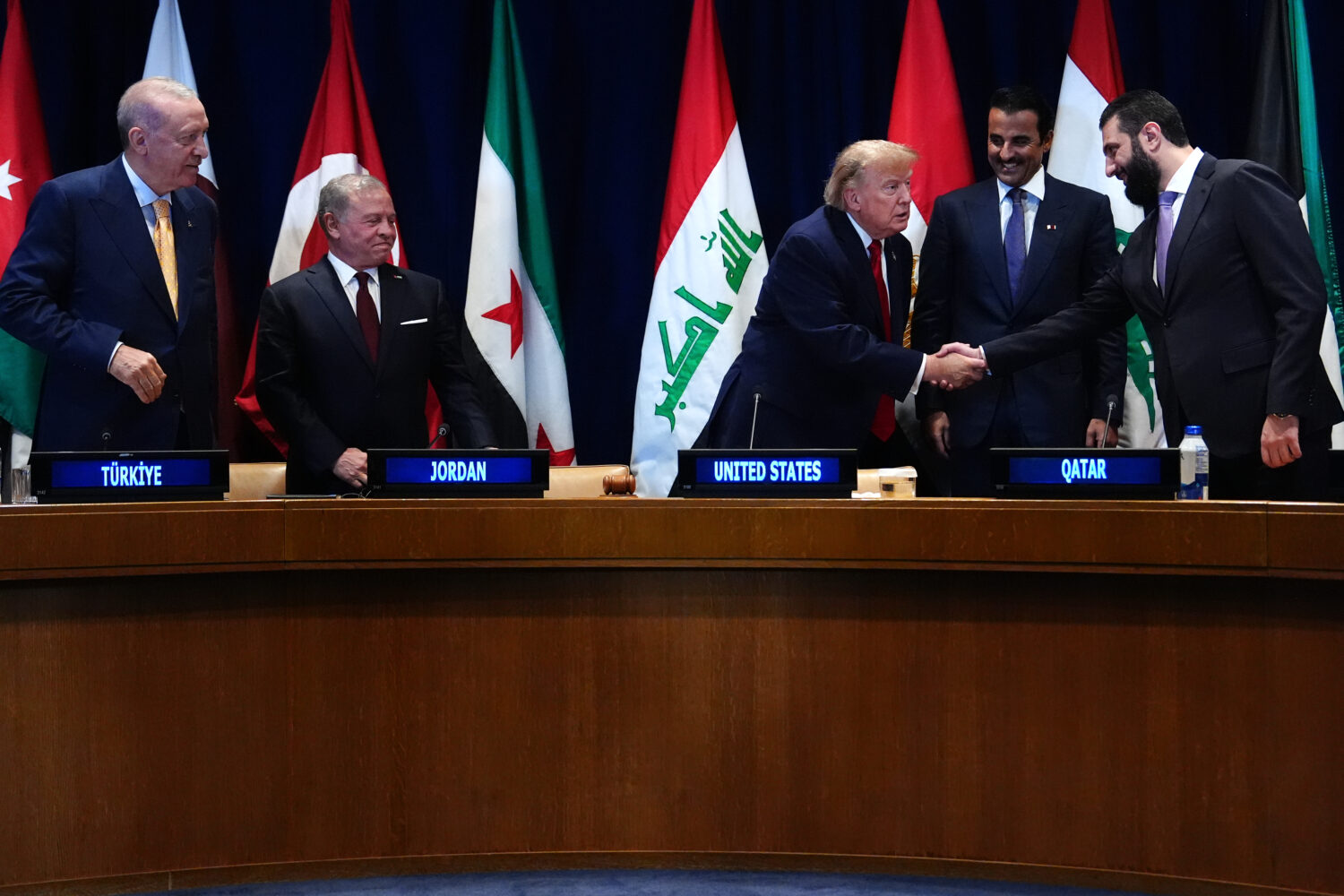 President Donald Trump shakes hands with Syria's President Ahmed al-Sharaa as Turkey's President Re...