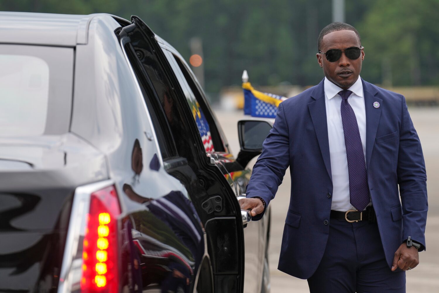 A member of the U.S. Secret Service stands before President Donald Trump arrives to board his limou...
