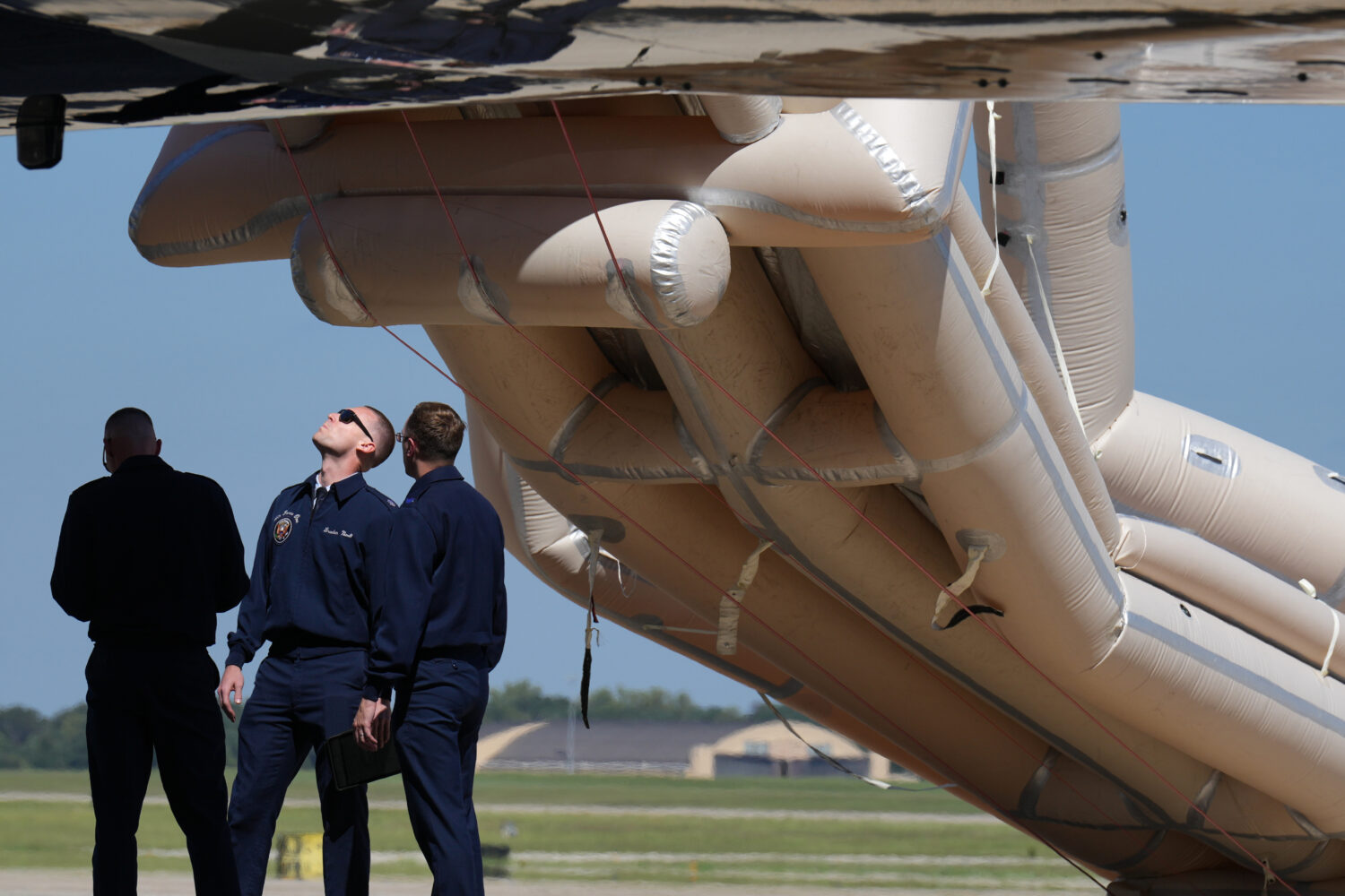 U.S, Air Force personnel work after an emergency inflatable slide deployed before President Donald ...