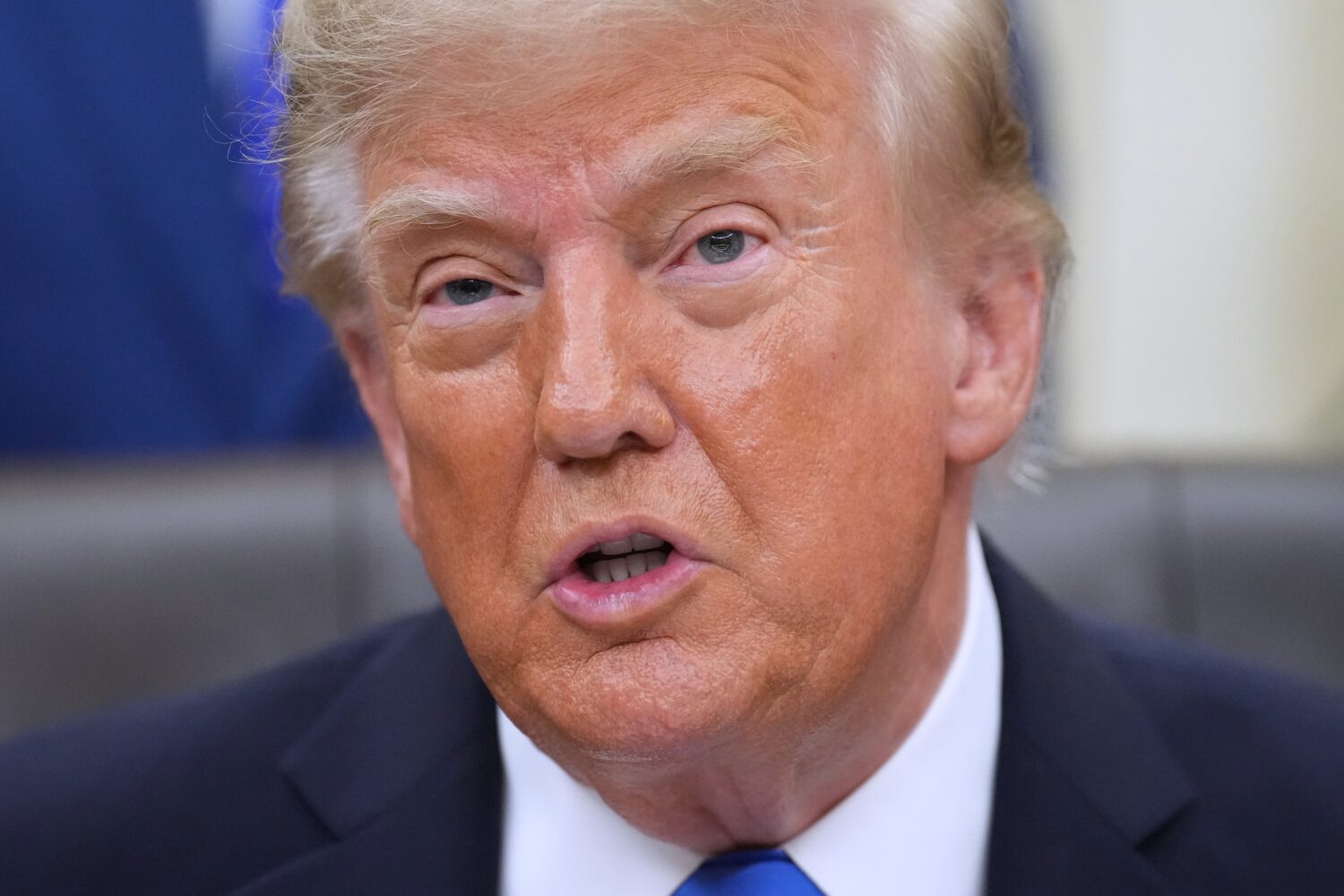 President Donald Trump speaks in the Oval Office of the White House during a meeting with travel ex...