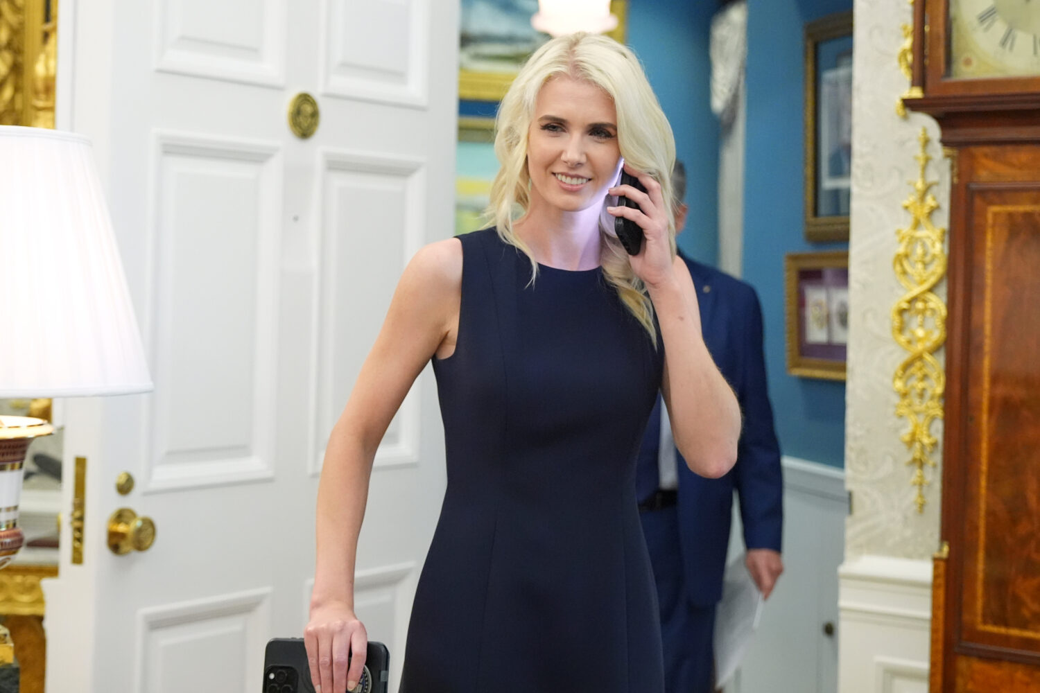 White House aide Natalie Harp is pictured using a cell phone as President Donald Trump speaks durin...