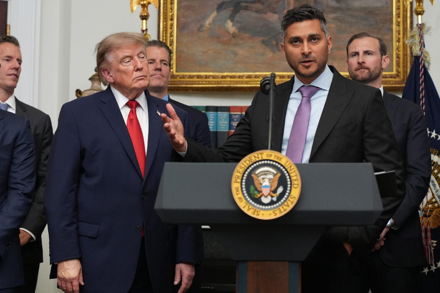 FILE - Kraken co-CEO Arjun Sethi speaks as President Donald Trump listens during a meeting with tec...