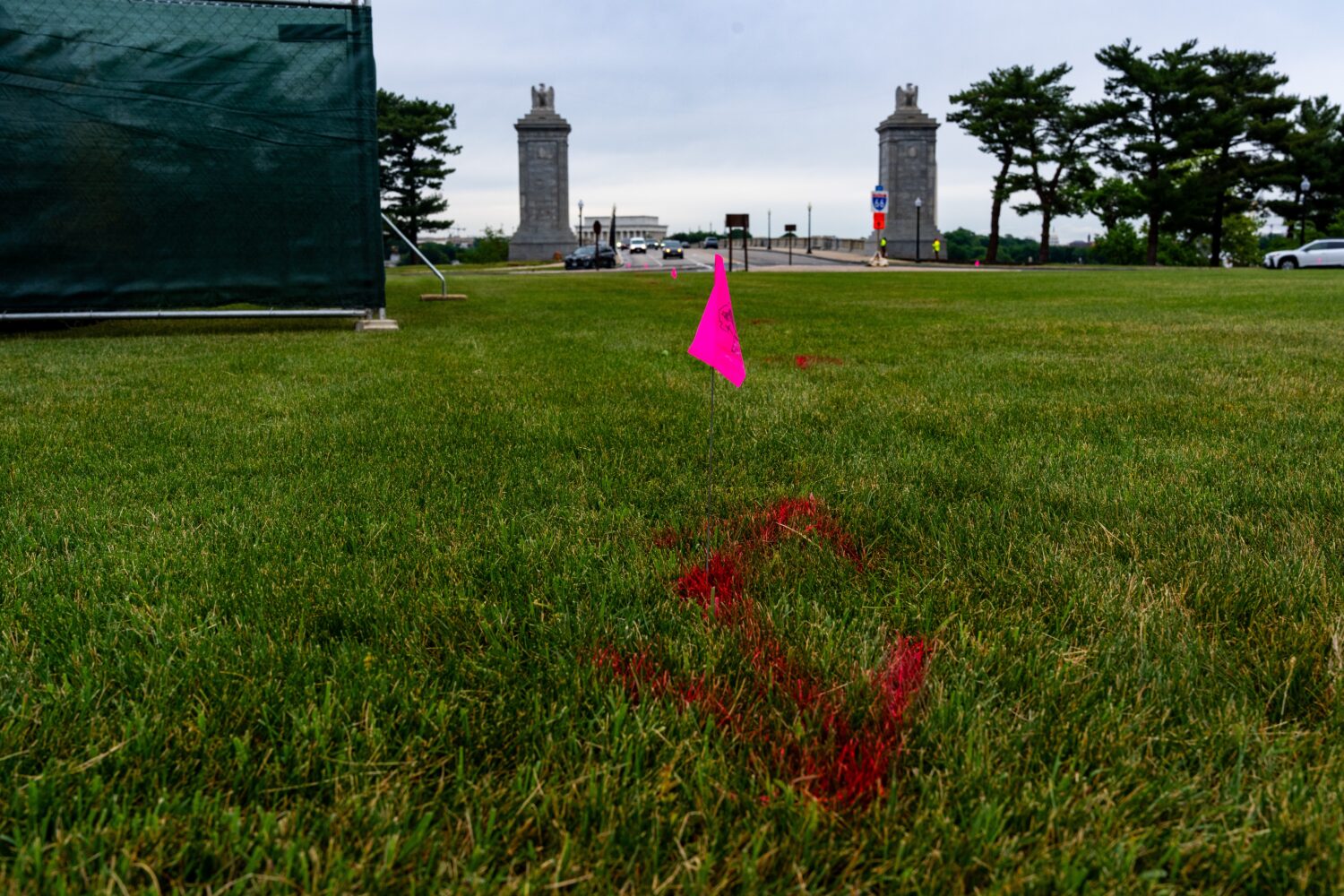 FILE - Flags are placed as workers survey the Memorial Circle, where President Donald Trump has pro...