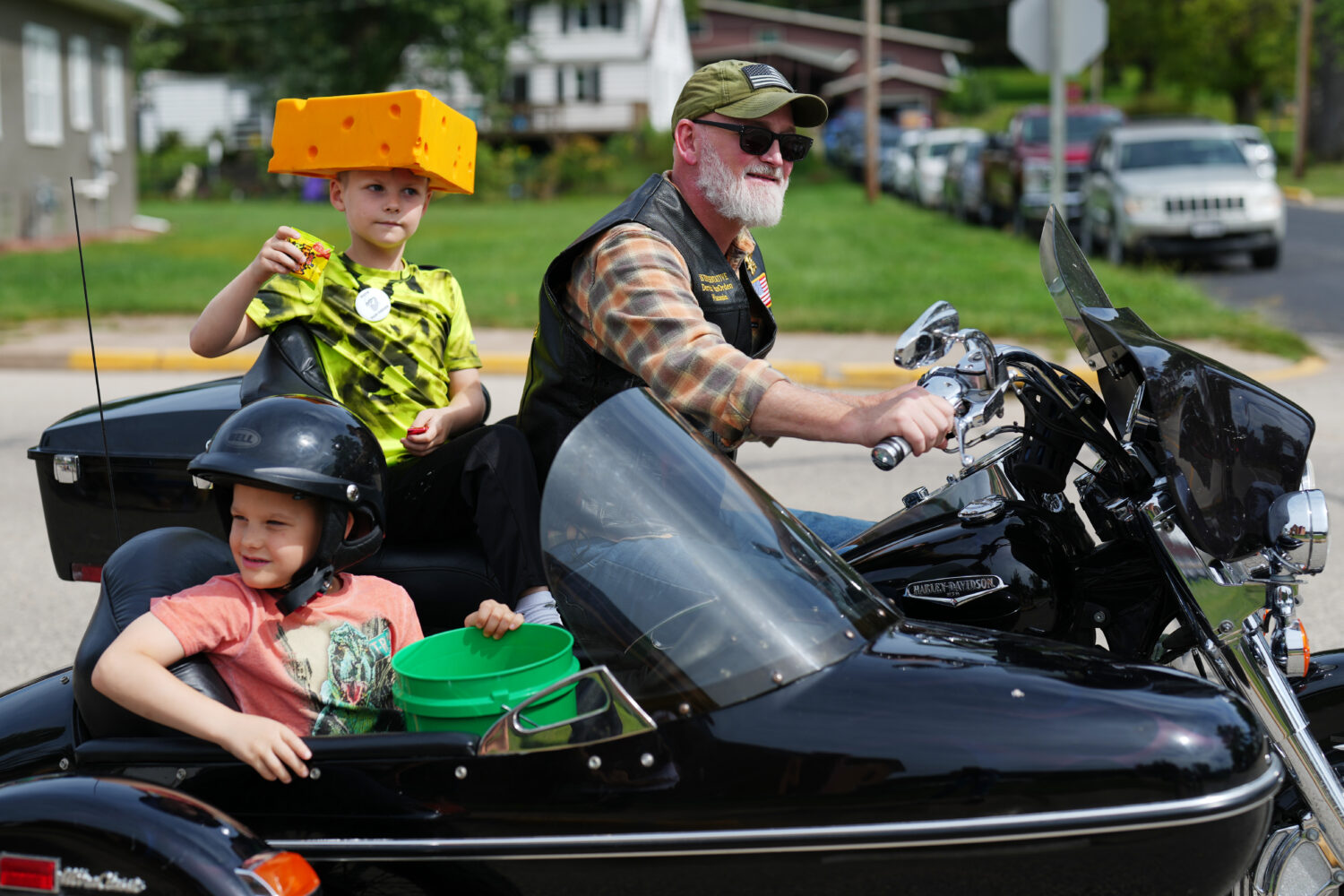 U.S. Rep. Derrick Van Orden rides his motorcycle in a Labor Day parade with his grandsons, Teddy an...