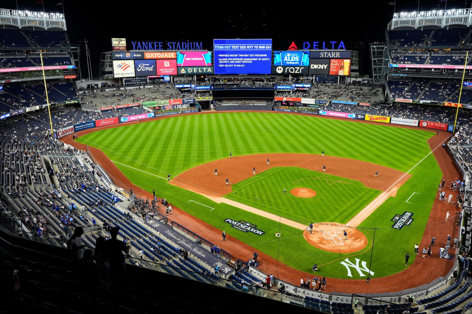 FILE - The grounds crew grooms the field before Game 3 of baseball's American League Division Serie...