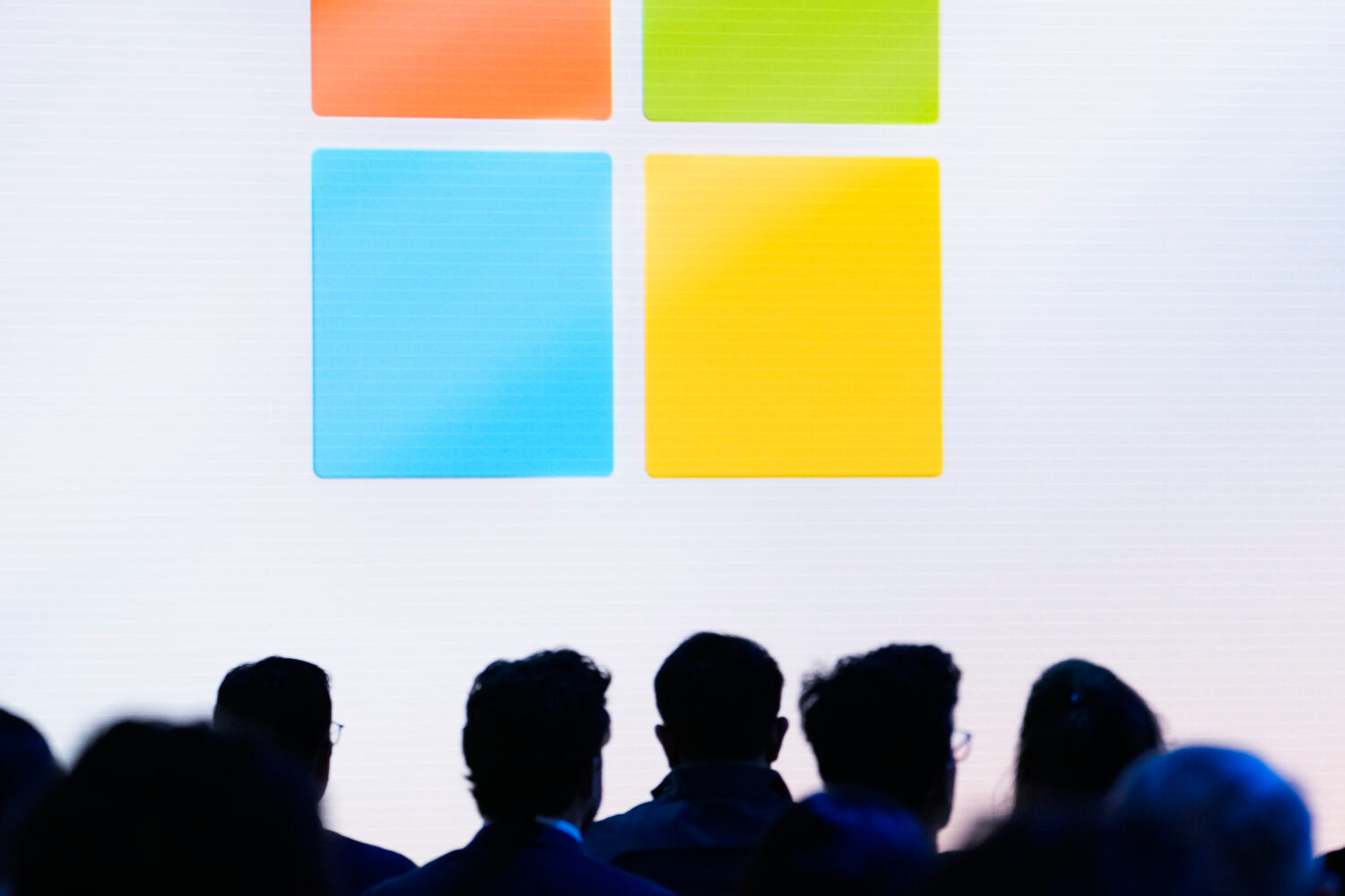 FILE - People attend a showcase event of the company's AI assistant, Copilot, ahead of the annual B...