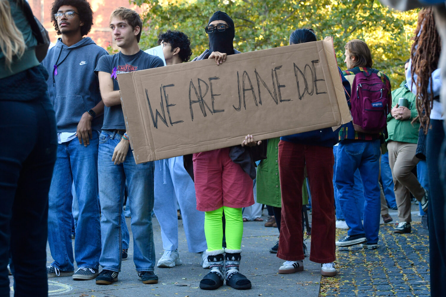 A demonstrator holds a sign reading "WE ARE JANE DOE" during a protest against Cornell University's...