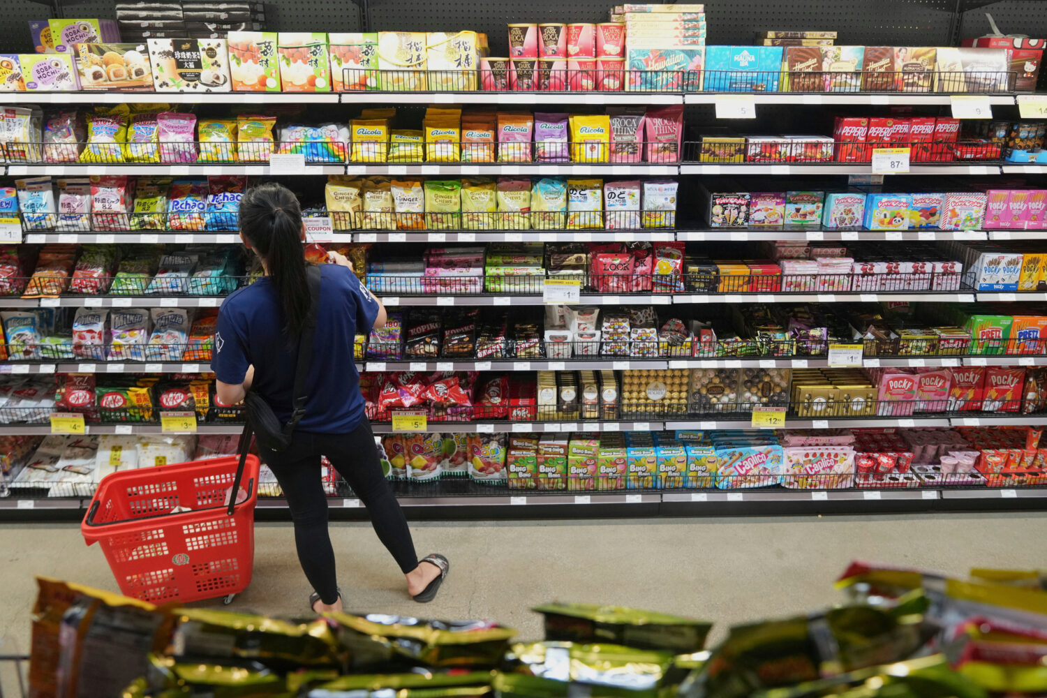 FILE - A customer buys Chinese made ginger candy at 99 Ranch Market, an Asian grocery store in Los ...