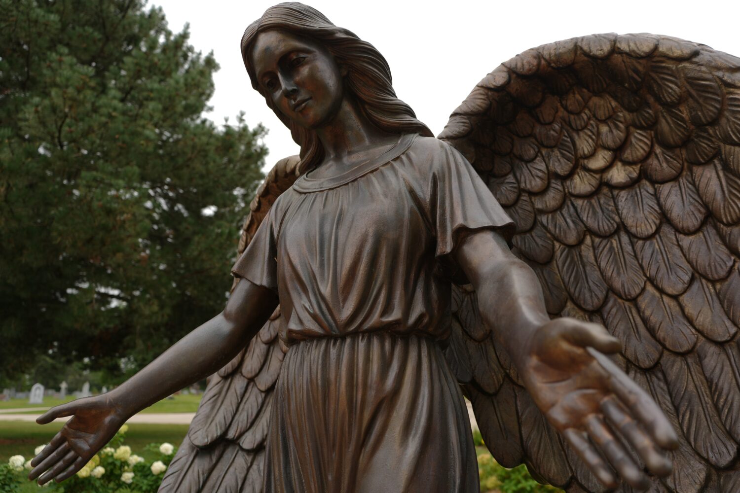 A sculpture of an angel stands at a memorial for survivors and lives lost to suicide dedicated by t...