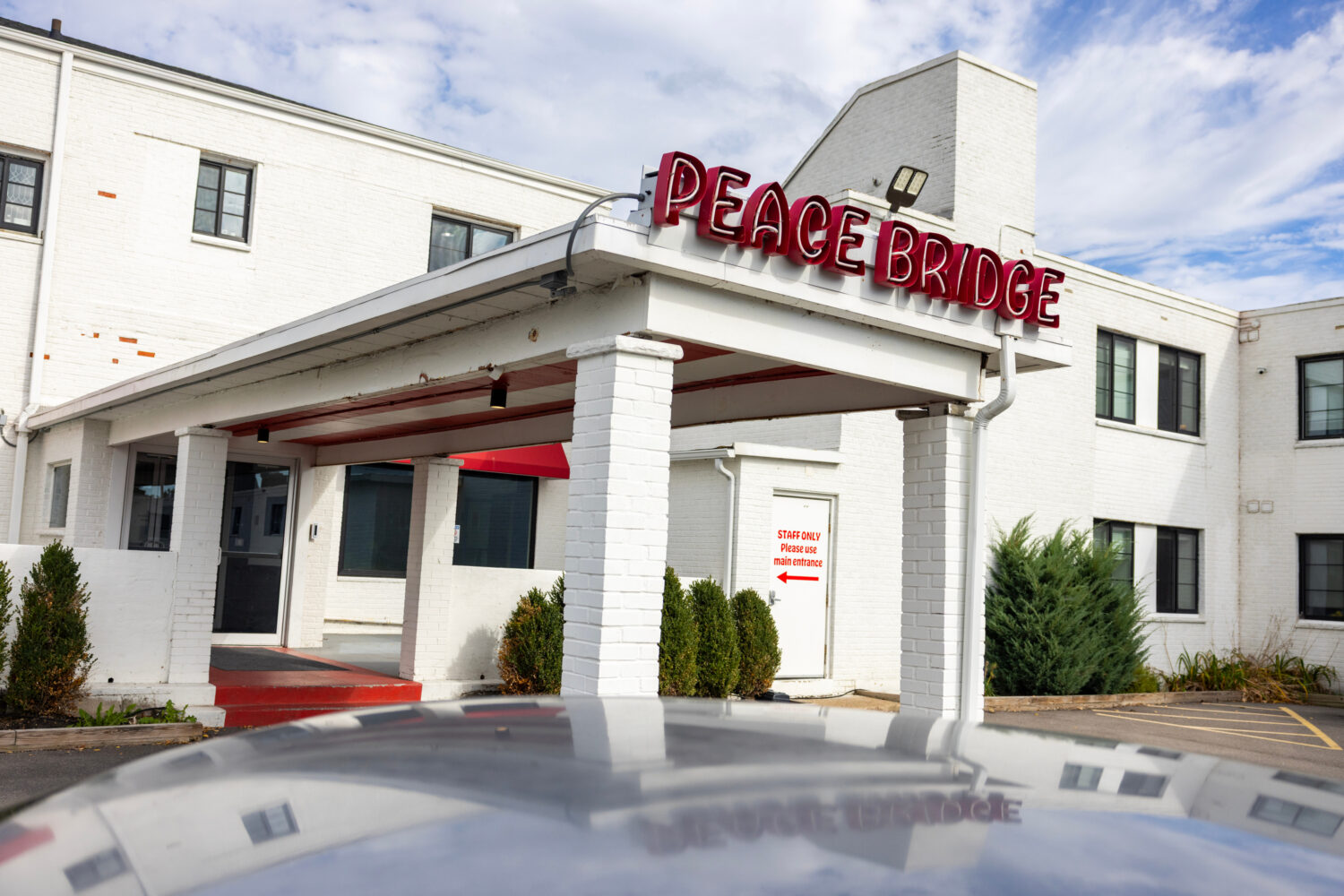 A sign is displayed for Peace Bridge Place apartments that have Viridi's lithium-ion battery energy...