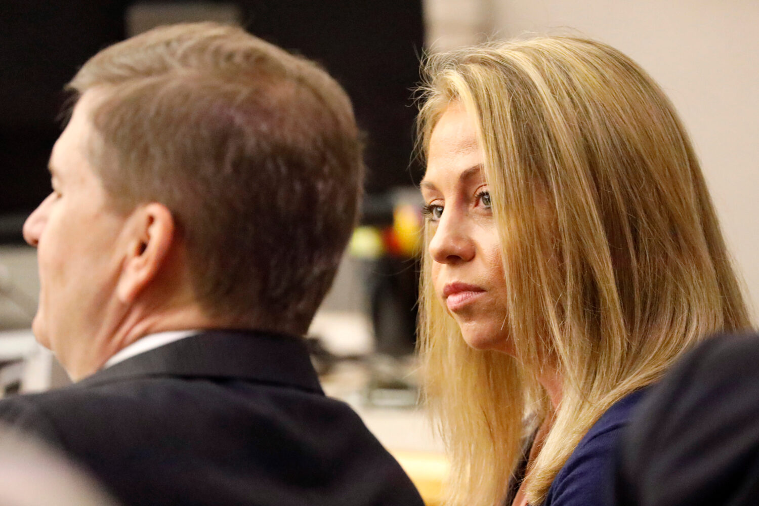 FILE - Fired Dallas police officer Amber Guyger looks toward her attorney before proceedings in her...
