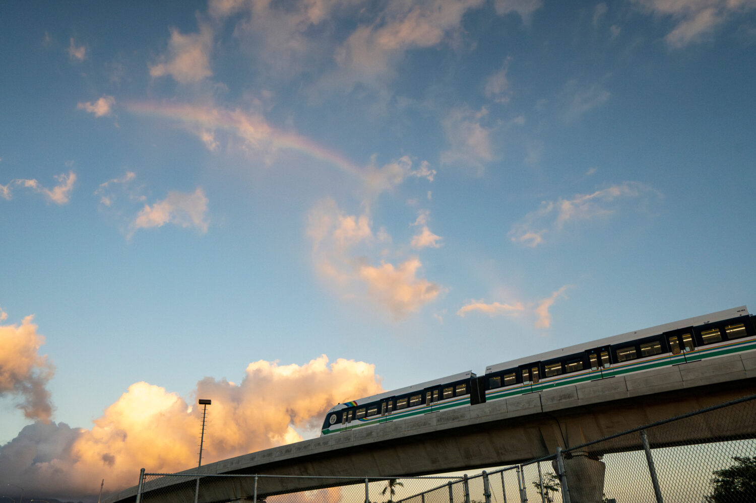 FILE - A rainbow arches over a Honolulu Skyline train at sunset, Sept. 19, 2024, in Honolulu. (AP P...