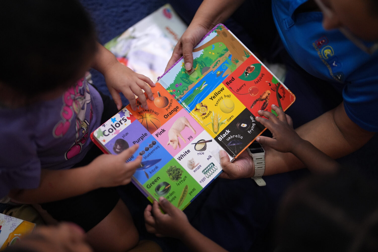 Children look through a book of first words at a Head Start preschool in Immokalee, Fla., Thursday,...