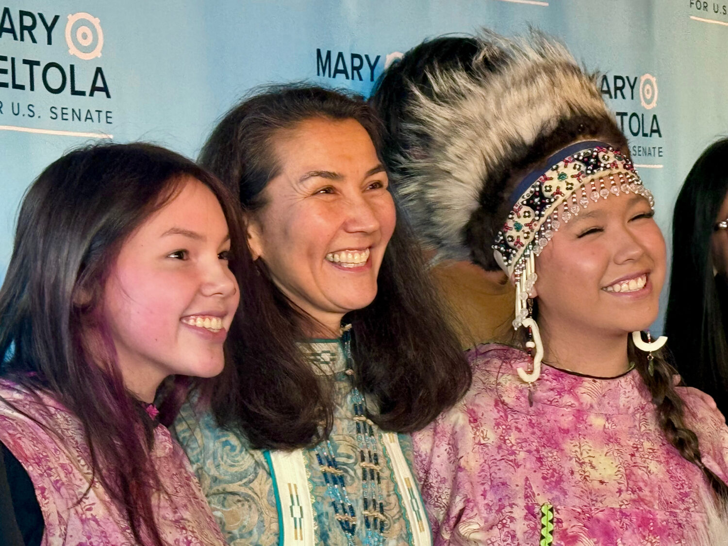 In this photo made with a smartphone, Democratic U.S. Senate candidate Mary Peltola, center, stands...