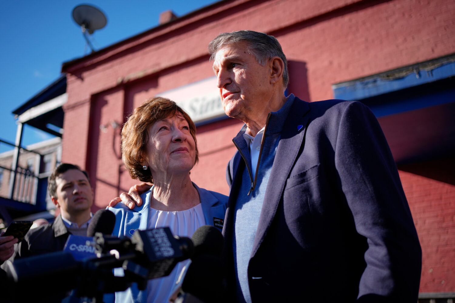 Sen. Susan Collins listens as former West Virginia Sen. Joe Manchin speaks to reporters following a...