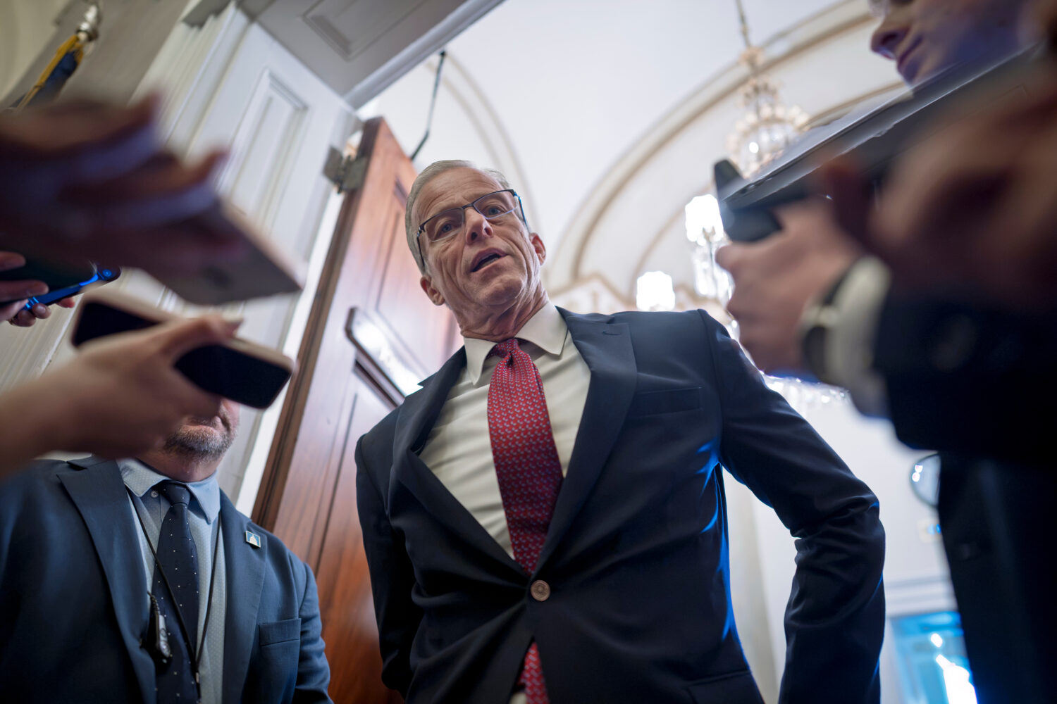 Majority Leader John Thune, R-S.D., responds to reporters asking questions as he enters his office ...