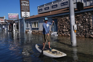 King tides inundate streets and flood homes and businesses along both US coasts