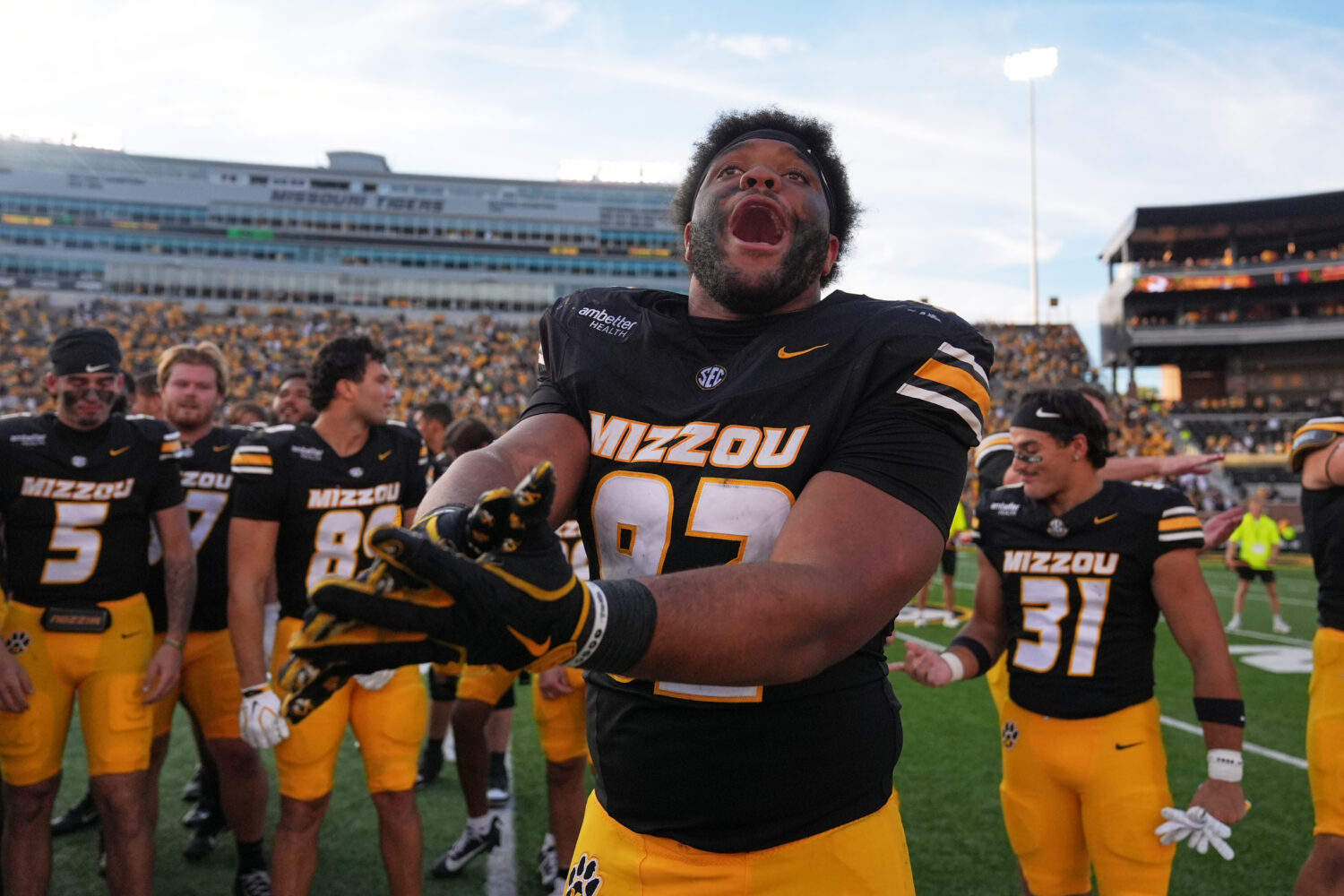 Missouri defensive tackle Jason Dowell celebrates a victory over Florida with his teammates followi...