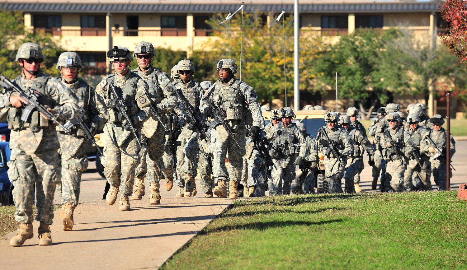 FILE - Soldiers from the 3rd Armored Cavalry Regiment storm the grounds of the Soldier Readiness Ce...
