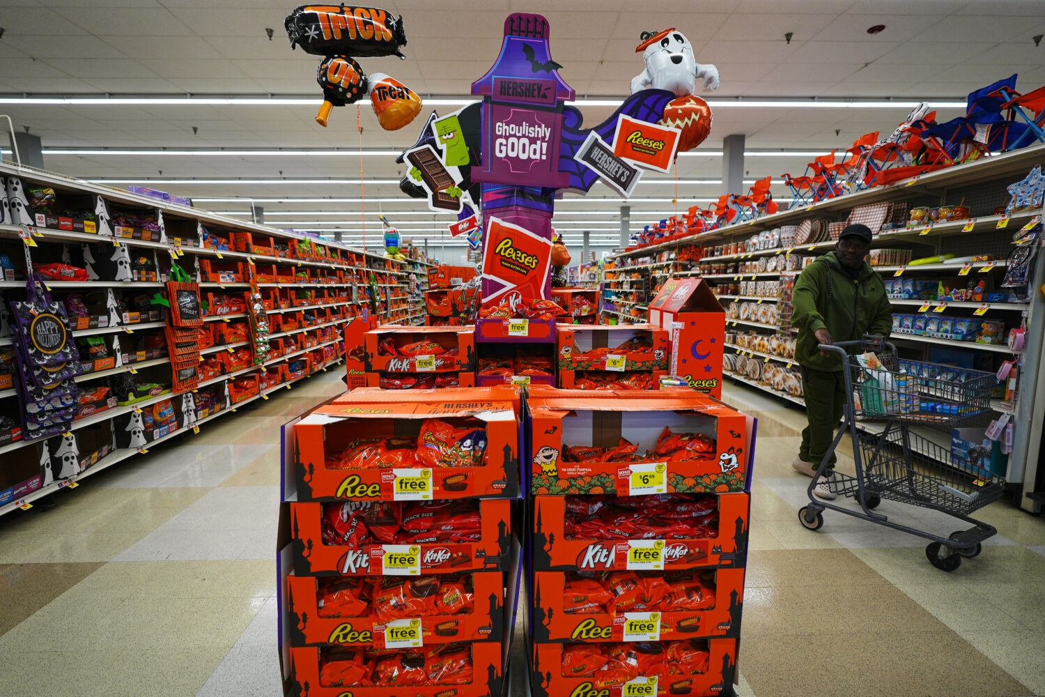 A shopper walks by a Halloween candy display at a Giant grocery store, Thursday, Oct. 22, 2026, in ...