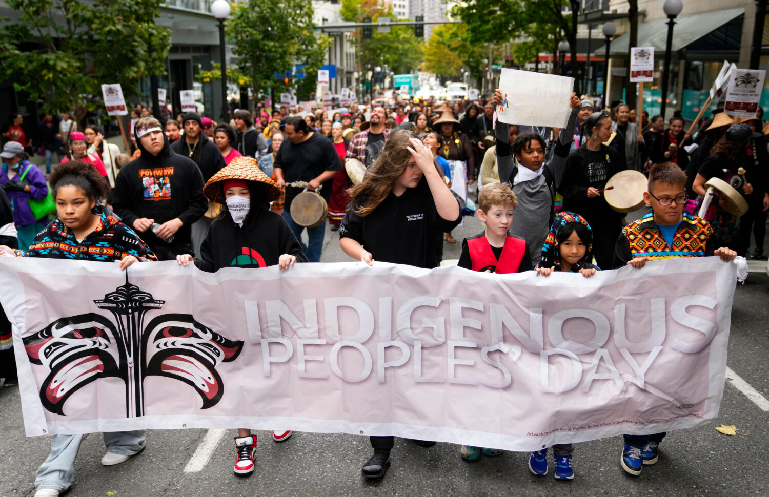 FILE - Young people hold a banner as they lead a celebratory march for Indigenous Peoples Day, Oct....