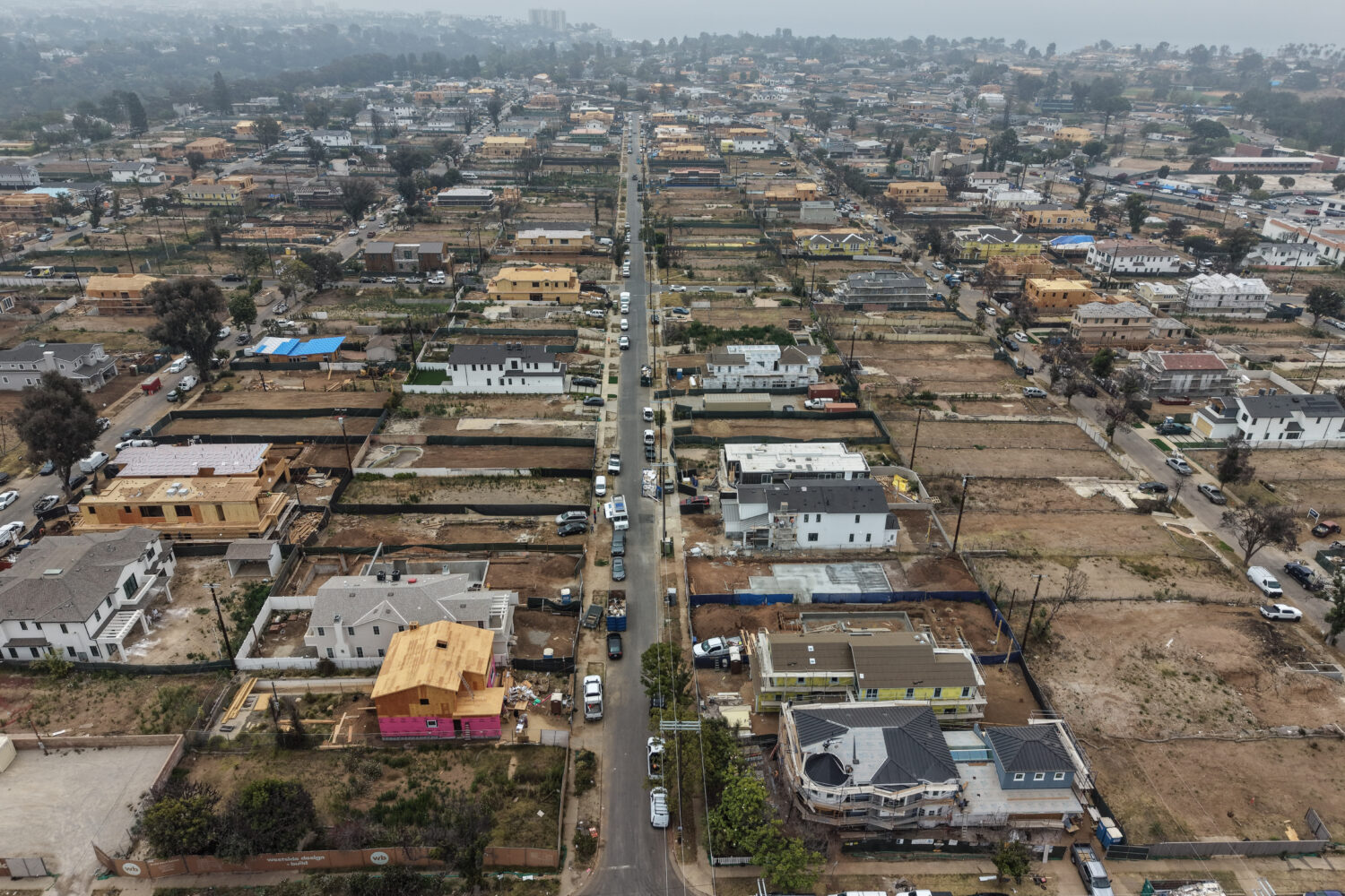 FILE - An aerial view shows homes under construction amid empty lots, June 4, 2026, more than a yea...