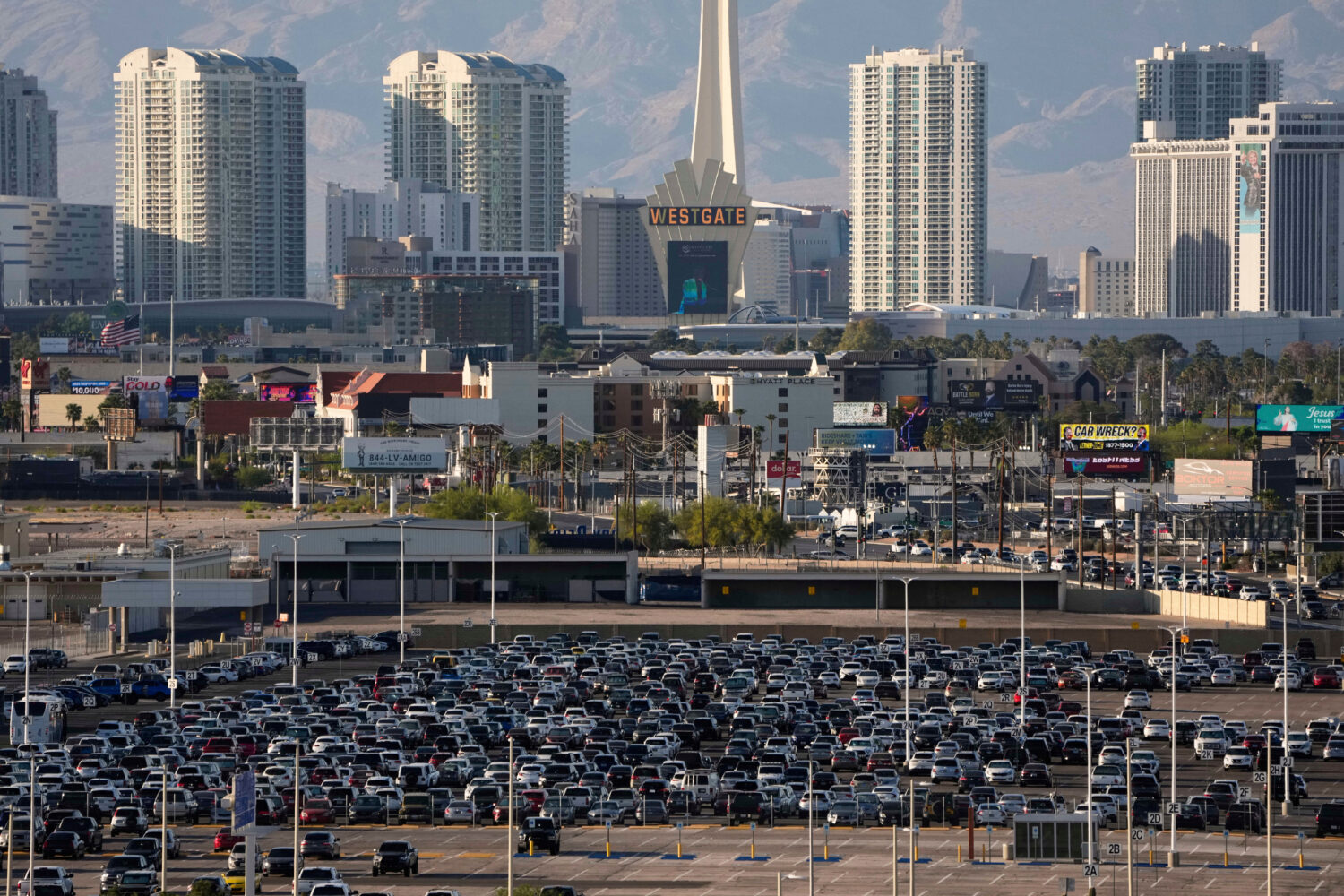 FILE - Cars fill a lot at Harry Reid International Airport near the Las Vegas Strip, April 9, 2025,...