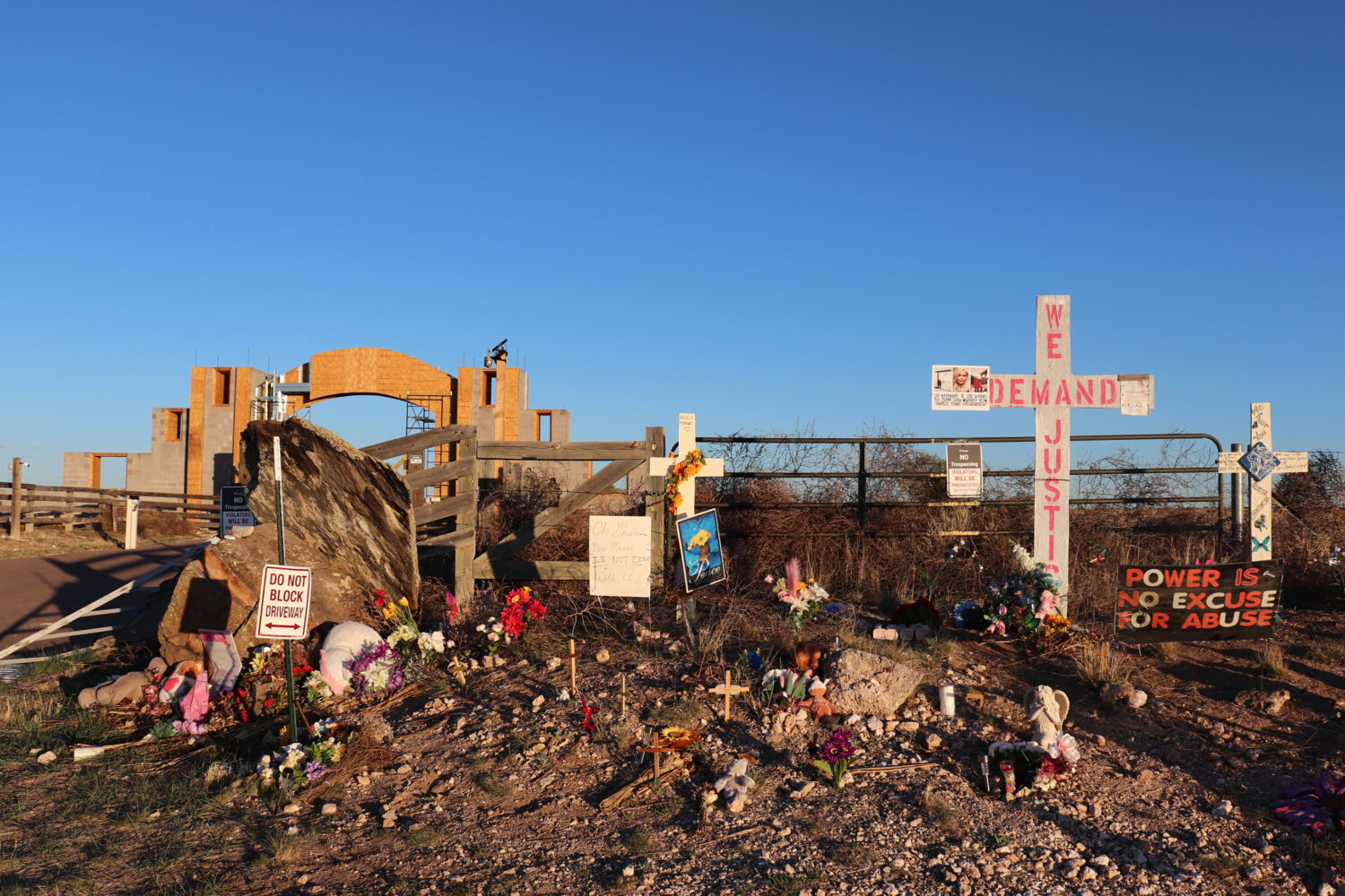 FILE - Crosses, flowers and other mementos are displayed outside Jeffrey Epstein's former Zorro Ran...