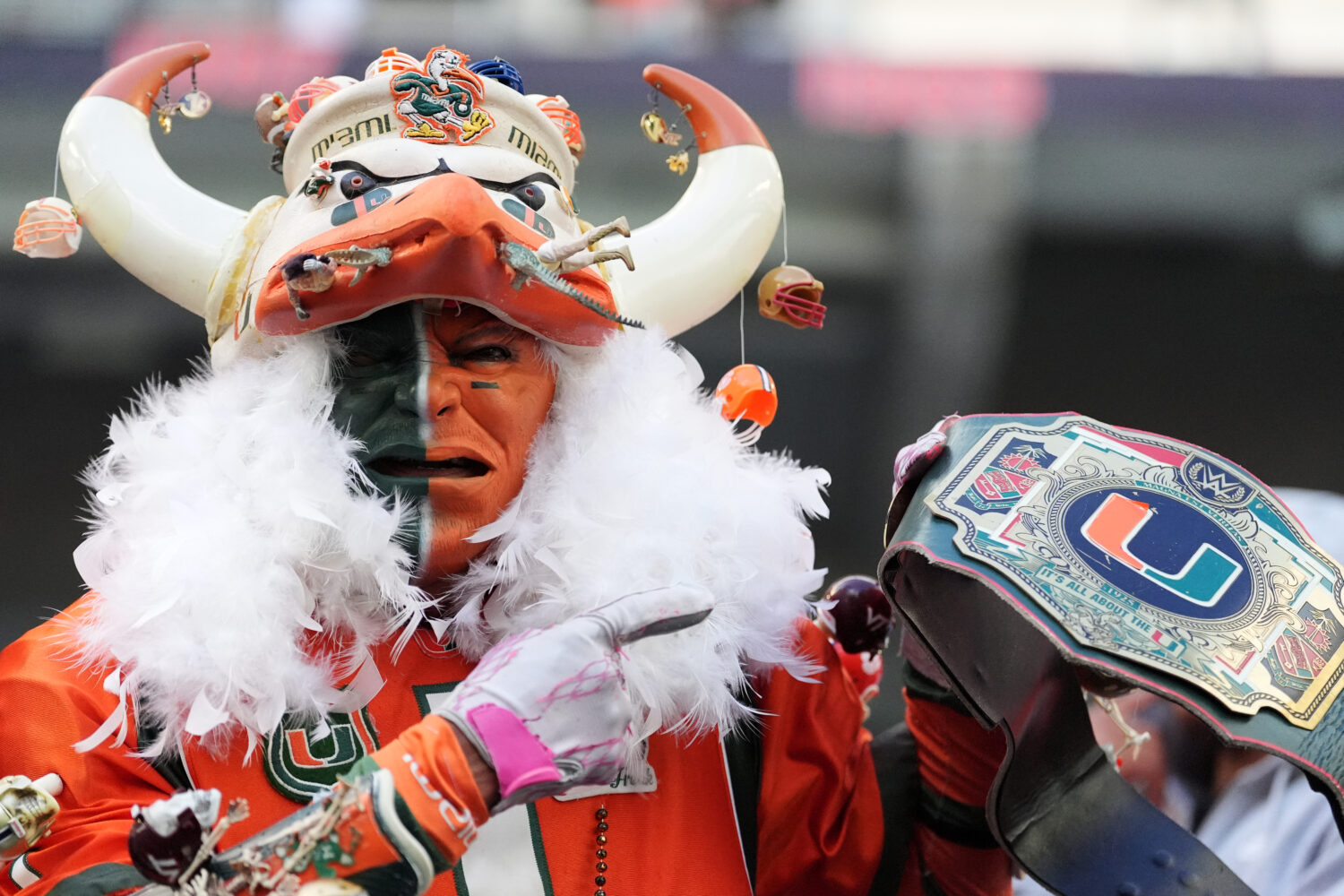 A Miami fan stands in the stands during the second half of an NCAA college football game between Mi...