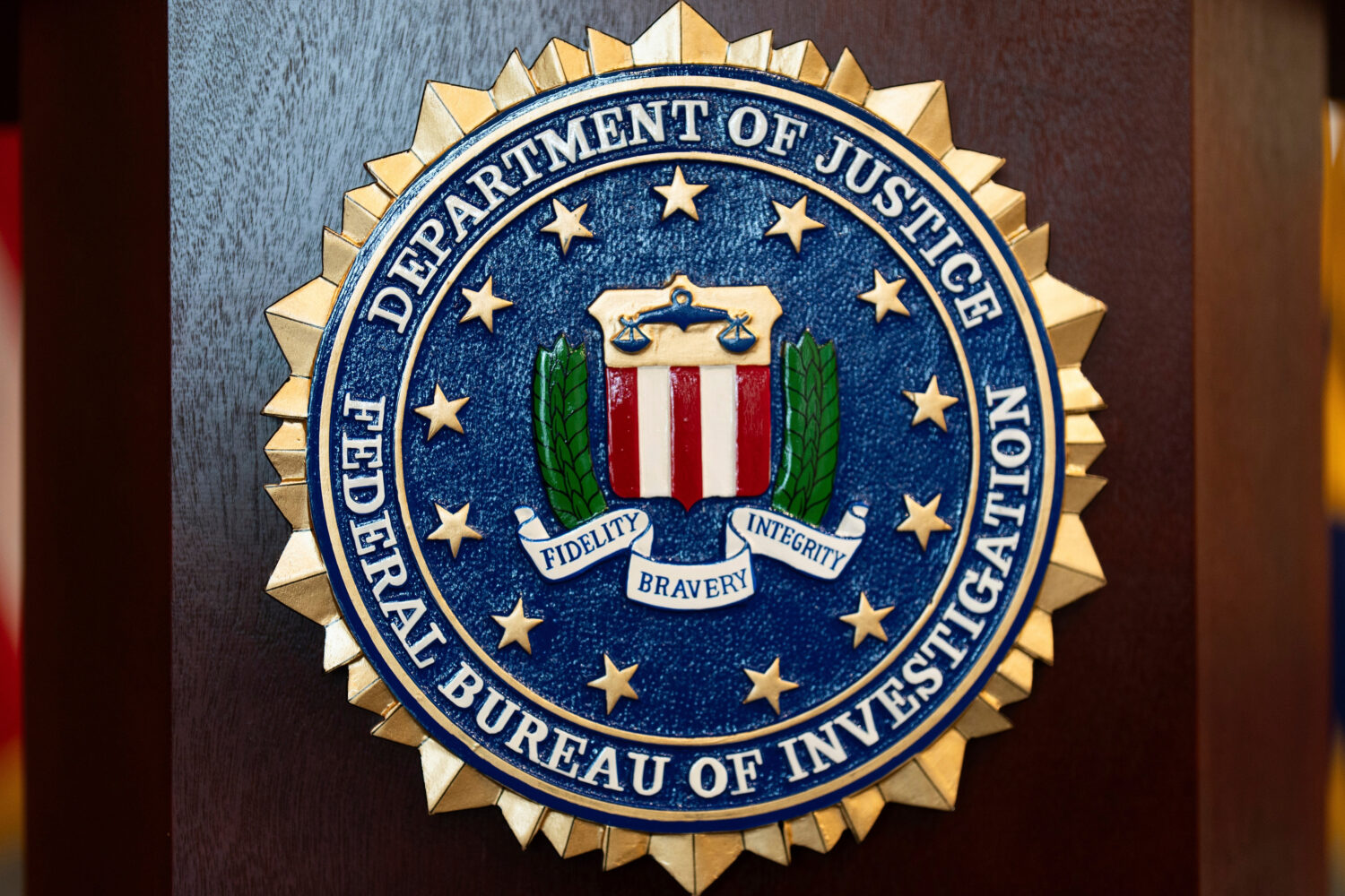 FILE - An FBI seal is displayed on a podium before a news conference at the field office in Portlan...