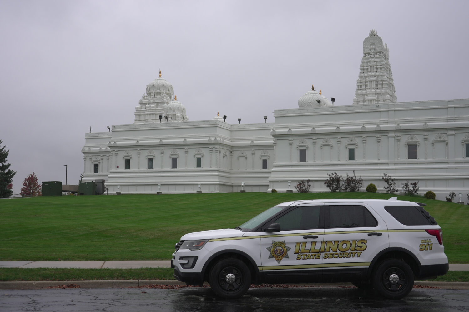 A security vehicle is parked outside of Sri Venkateswara Swami (Balaji) Temple in Aurora, Ill., Thu...