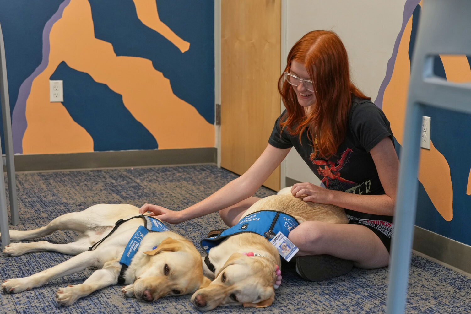 Maddie Cornwell, a senior at Evergreen High School, visits with a pair of support dogs named Polent...
