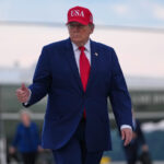 Trump puts new Russia sanctions passed by Congress on hold, saying waiver is in US national interest