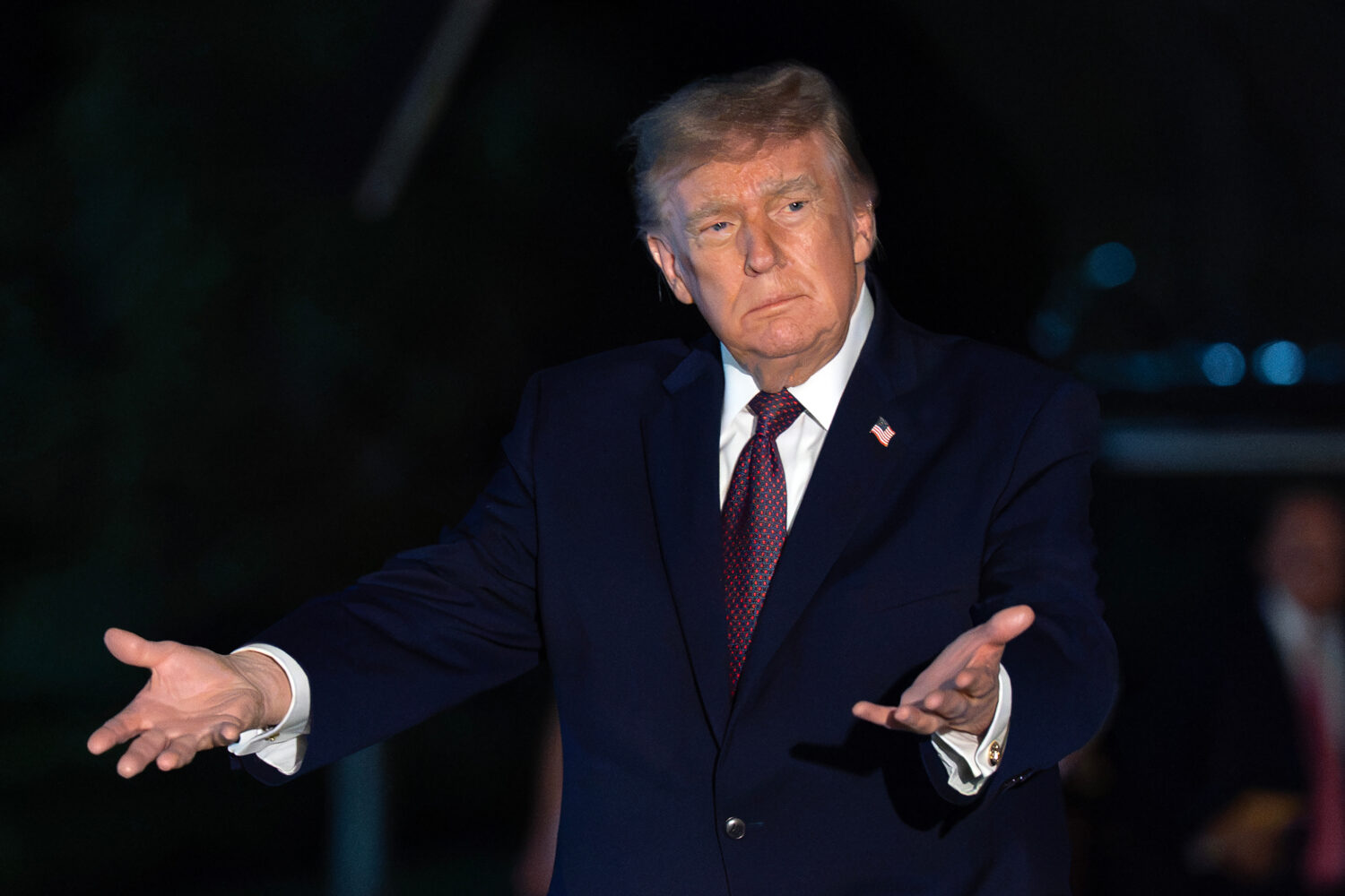 President Donald Trump gestures to reporters as he walks on the South Lawn upon his arrival to the ...