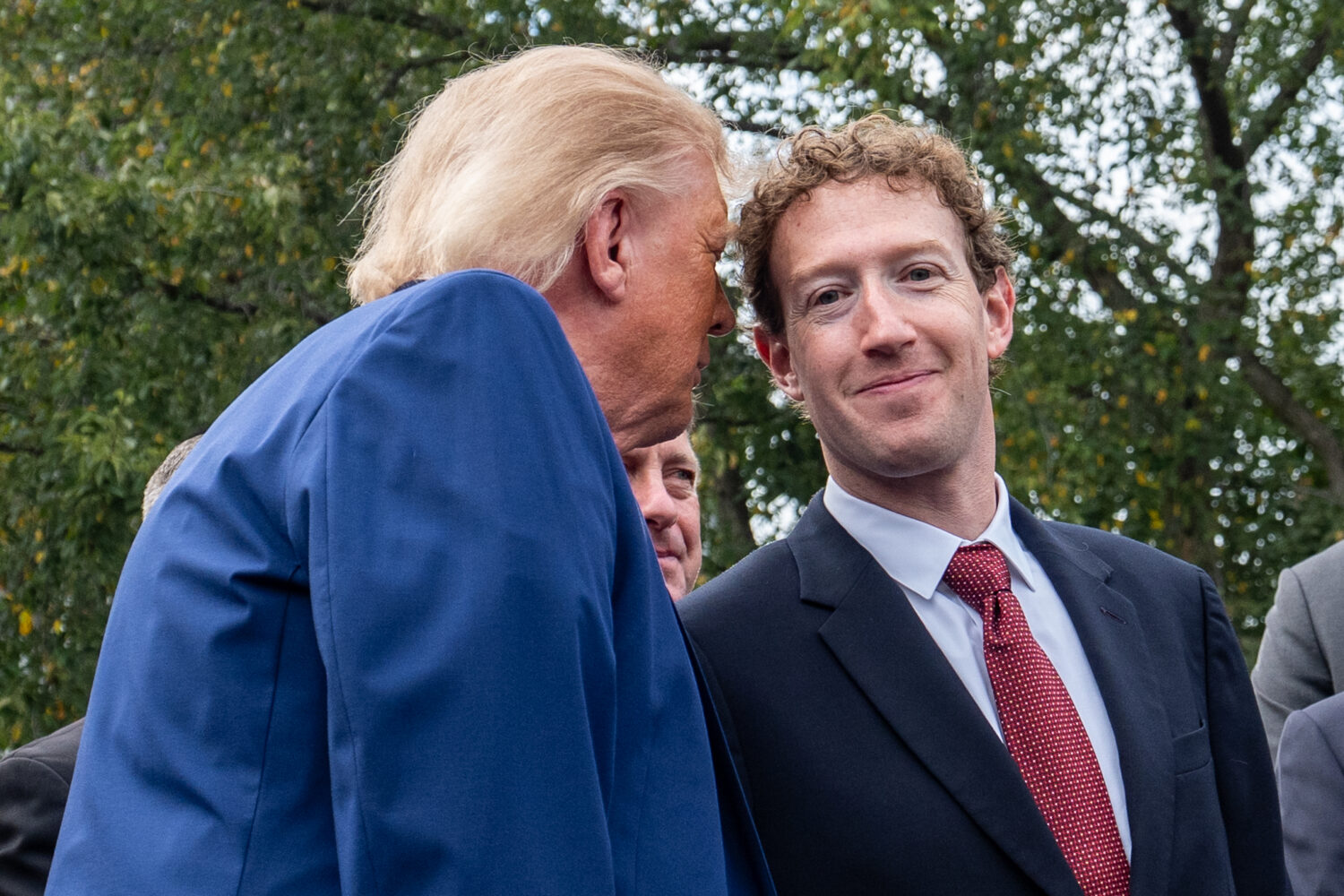 President Donald Trump talks with Meta CEO Mark Zuckerberg as he speaks with reporters outside the ...