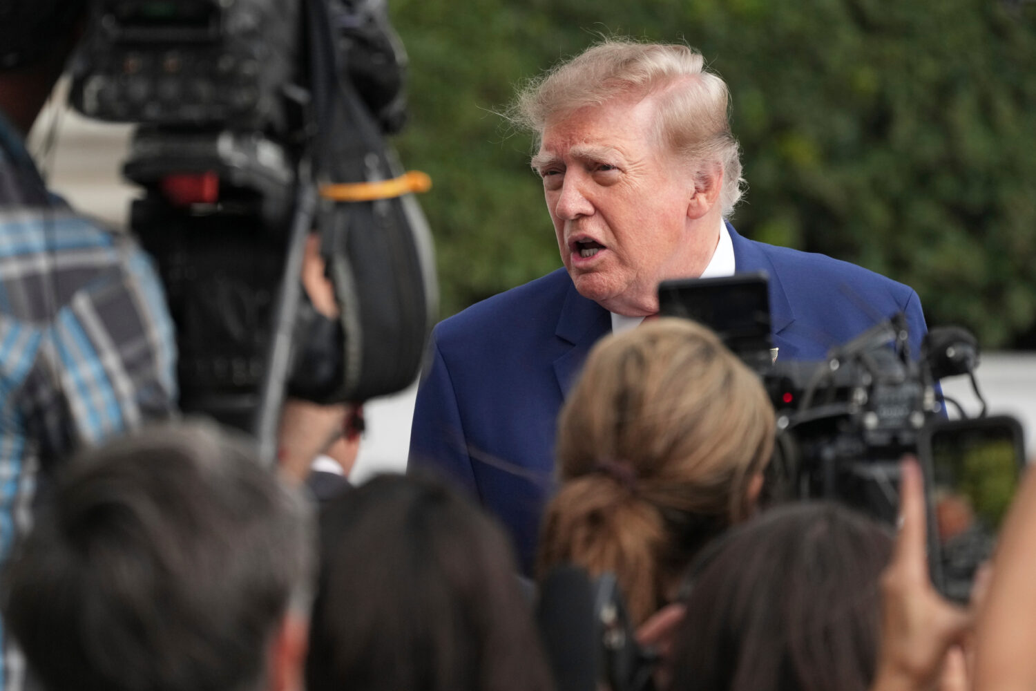 President Donald Trump speaks to reporters on the South Lawn of the White House, Friday, Oct. 16, 2...