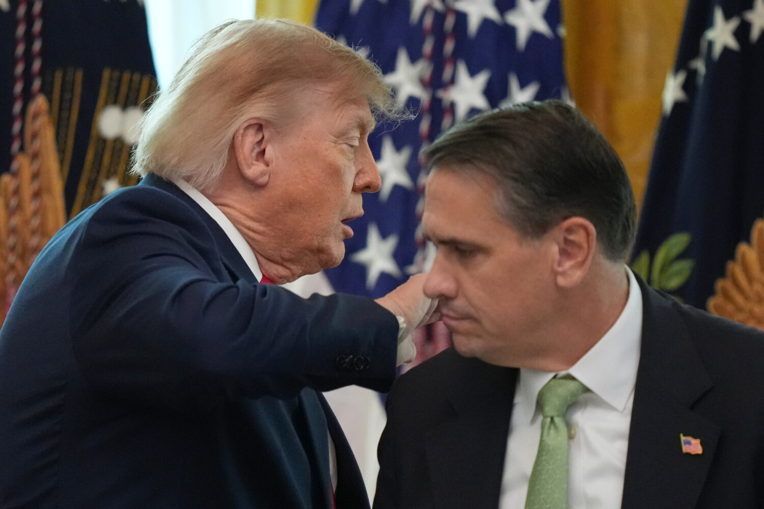 President Donald Trump walks past Attorney General Todd Blanche after speaking at a roundtable even...