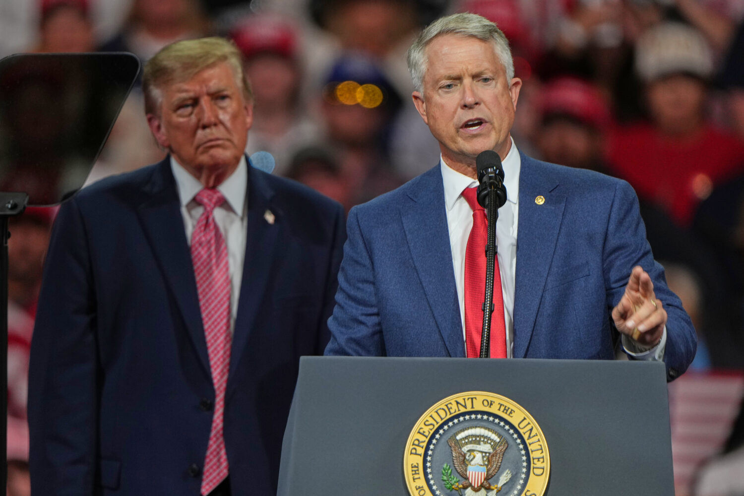 President Donald Trump listens as Sen. Roger Marshall, R-Kan., speaks at a campaign rally at Heartl...