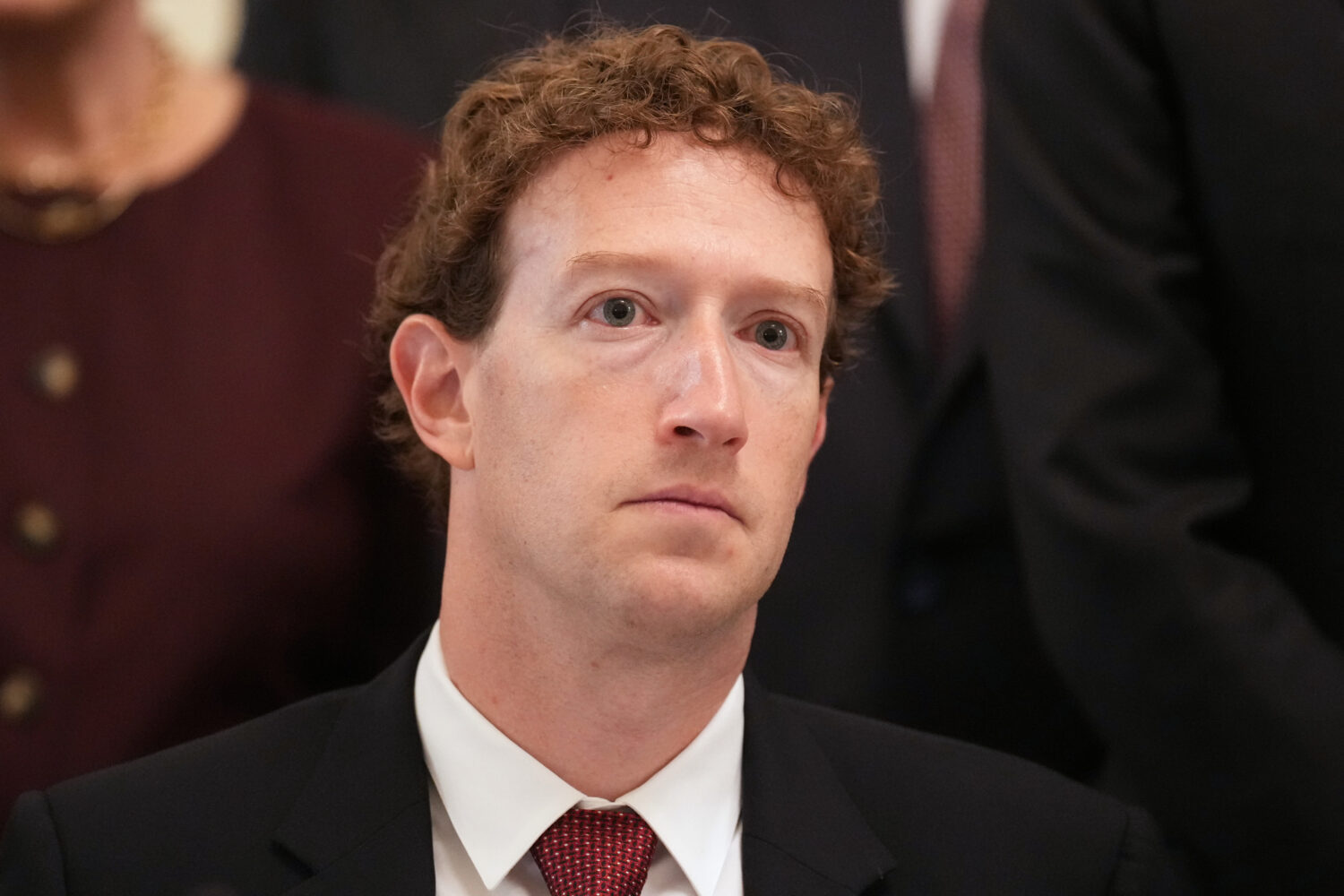 Meta CEO Mark Zuckerberg listens as President Donald Trump speaks in the East Room of the White Hou...
