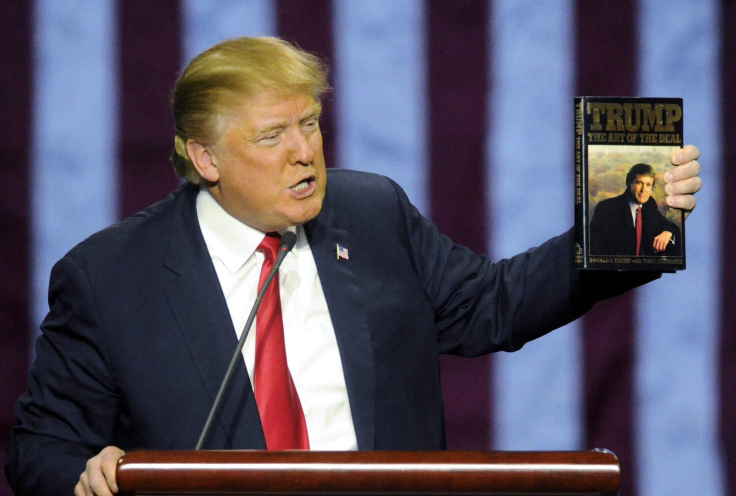 FILE - Then-Republican presidential candidate Donald Trump holds up his book "The Art of the Deal,"...