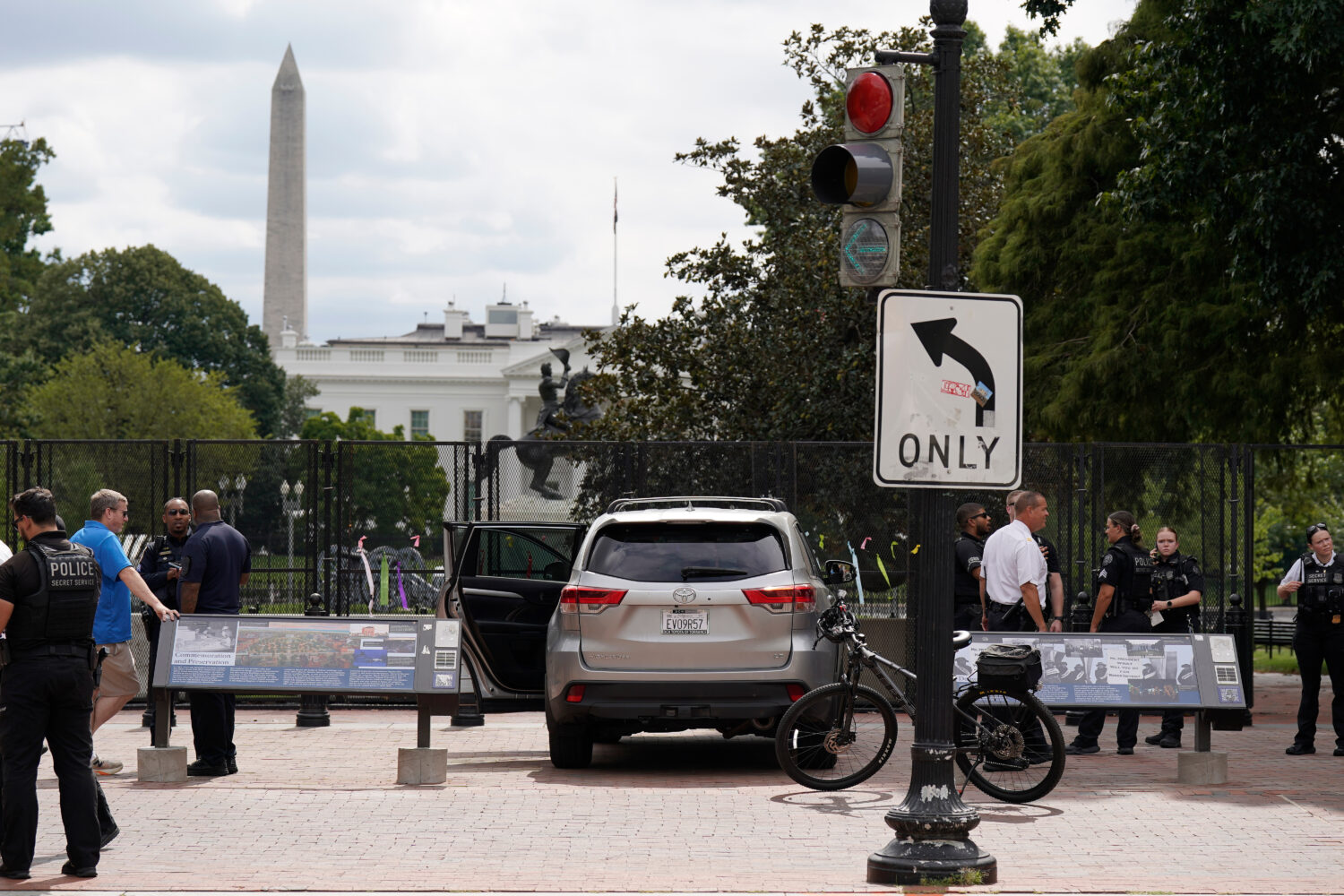 U.S. Secret Service Police stand near a car that sits parked on a sidewalk near the White House aft...