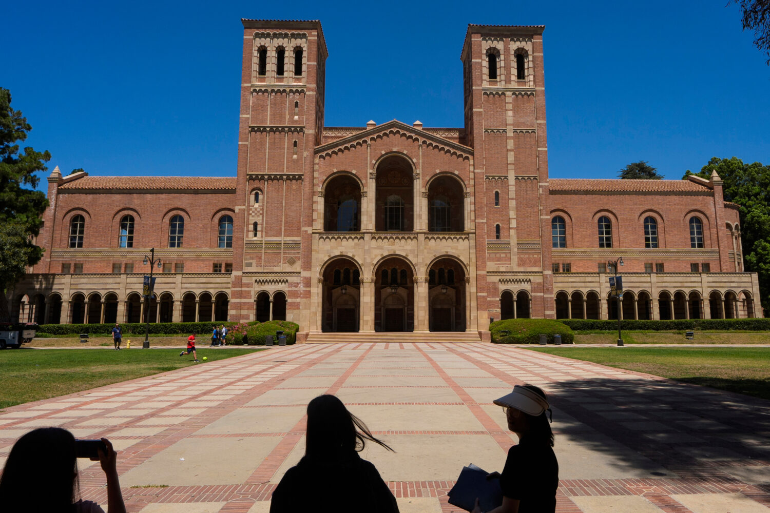 FILE - Visitors take pictures in front of Royce Hall at the University of California's Los Angeles ...