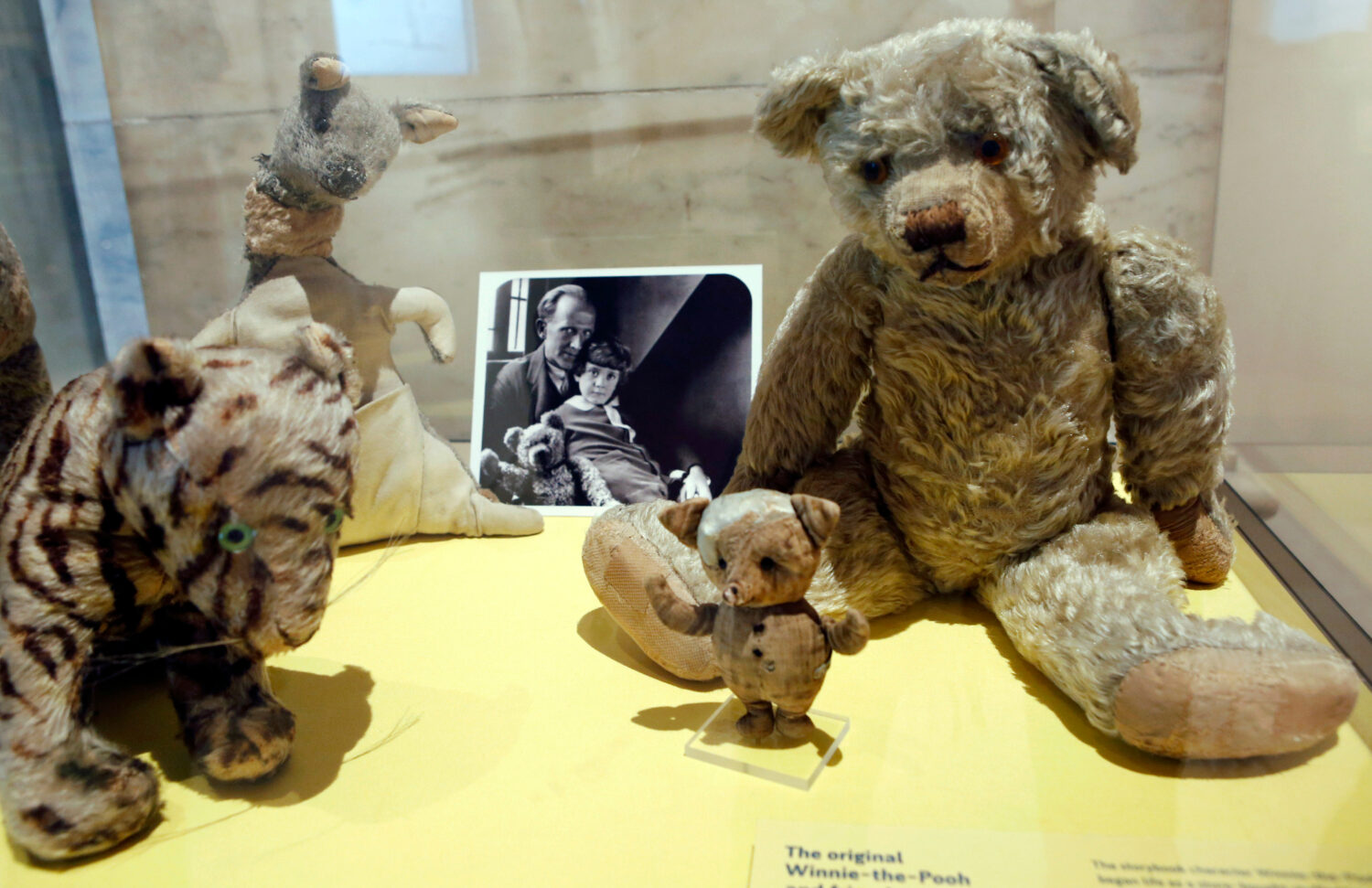FILE - A photograph of author A. A. Milne with his son Christopher Robin is displayed beside Milne'...